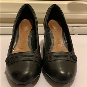 Well loved and cared for black pumps by Clarks.